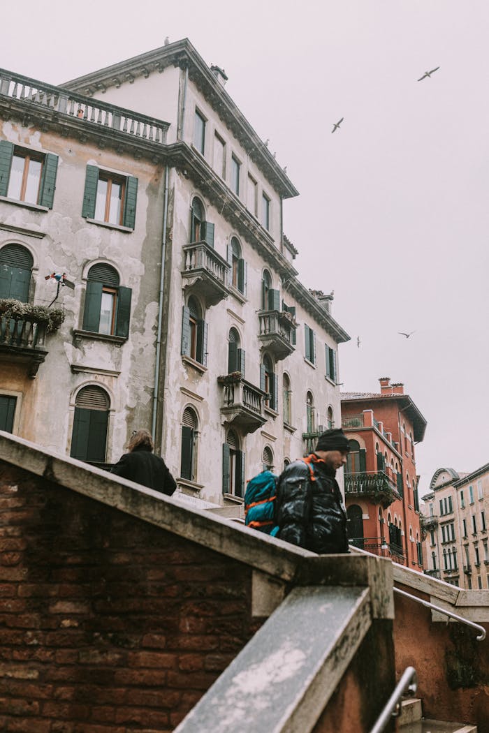 Explore a Venetian street with historic architecture and a peaceful ambiance. Perfect for travel enthusiasts.